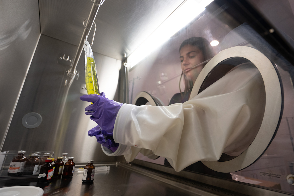 Nurse mixing a vitamin bag in a sterile field